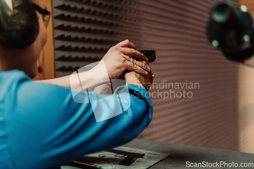 Image of The trainer explaining to the man how to use the gun. Training in the shooting range