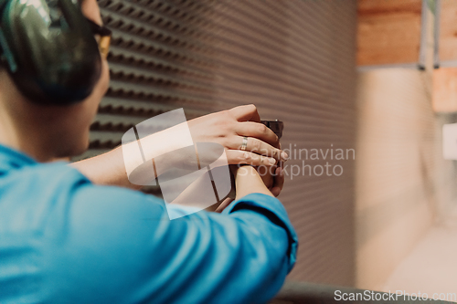 Image of The trainer explaining to the man how to use the gun. Training in the shooting range