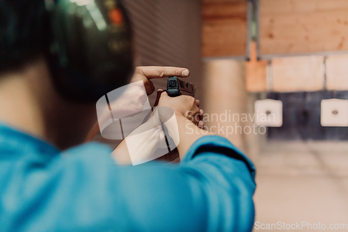 Image of The trainer explaining to the man how to use the gun. Training in the shooting range