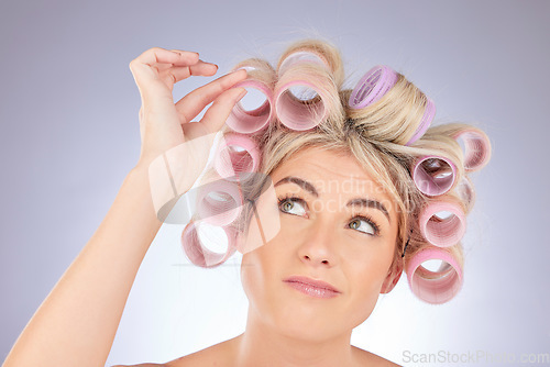 Image of Hairstyle, roller and woman thinking in a studio doing a natural, healthy and curly hair. Self care, confused and a female model with curler for beauty wellness isolated by a white background.