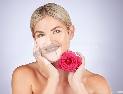 Image of Beauty, studio portrait or happy woman with flower for facial cleaning, organic skincare or natural cosmetics. Face, sustainable dermatology or makeup person with self love rose on white background