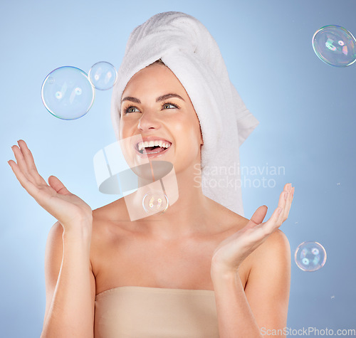 Image of Happy, studio face and woman with bubbles for skincare, body cleaning bath or morning hygiene wash. Bathroom, beauty happiness or person with smile, wellness or self care hydration on blue background