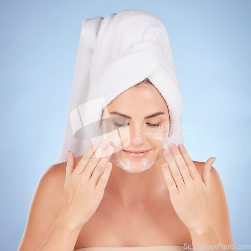 Image of Shower, woman and washing face with foam in studio, blue background and cleaning cosmetics. Happy female model, facial skincare and soap for healthy aesthetic glow, dermatology or moisturizing beauty