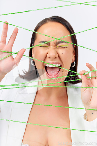 Image of Makeup, fashion and strings with woman screaming in studio for creative, art and cosmetics. Abstract, cotton and texture with face of model on white background for designer, shouting and textile