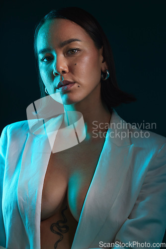 Image of Sexy, portrait and fashion with a woman on a studio background for a luxury aesthetic. Creative, young and an Asian model or girl with a suit or vintage and isolated on a dark or black backdrop