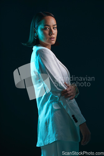 Image of Professional, portrait and woman in suit on a dark background for a corporate aesthetic. Serious, fashion and an Asian model or girl in clothes for work and isolated on a black backdrop for business