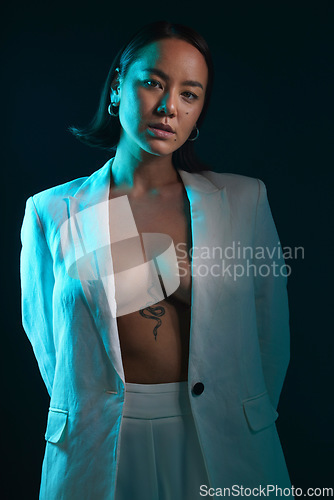 Image of Dark, portrait and fashion with a woman on a studio background for a luxury aesthetic. Creative, young and an Asian model or sexy girl with a suit or vintage and isolated on a black backdrop