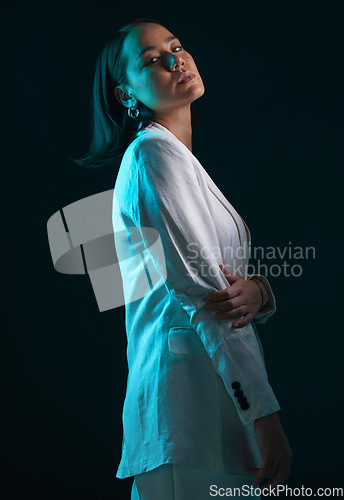 Image of Fashion, portrait and a woman in a suit on a dark background for a corporate aesthetic. Serious, stylish and an Asian model or girl in clothes for work and isolated on a black backdrop for business