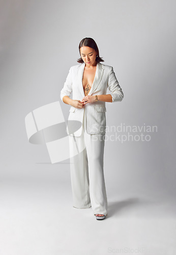 Image of Fashion, suit and asian woman with style or elegance in studio or white background with classy outfit. Trendy, cool and girl with vintage or luxury clothes or edgy, creative and smart casual person.