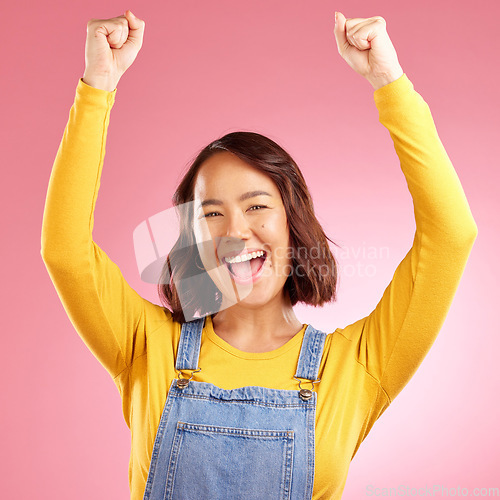 Image of Happy, celebration and success with portrait of asian woman in studio for party, winner or motivation. Wow, freedom and prize with face of person cheering in pink background for yes, bonus or excited