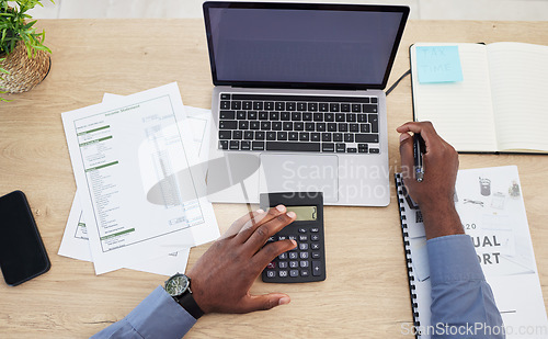 Image of Hands, writing and finance with calculator, desk or budget for investing, tax or saving by blank laptop in office. Financial advisor, pc and mockup space on screen, income and expenses with banking