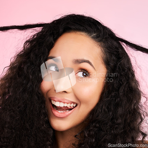 Image of Beauty, curly hair and smile with face of woman in studio for cosmetics, textures and salon treatment. Shampoo, skincare and hairstyle with model on pink background for self care, facial and glow