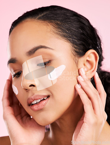 Image of Face, cream and beauty of a woman with skin care, dermatology and natural glow. Headshot of a young female aesthetic model with hands for moisturizer, cosmetics or sunscreen for wellness