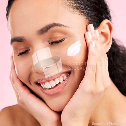 Image of Skincare, happy and woman with face cream in studio isolated on a pink background. Smile, beauty and natural model with moisturizer, cosmetic and apply dermatology product for wellness and health