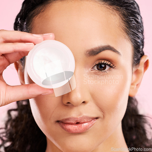 Image of Face, skincare and woman with cream jar in studio isolated on a pink background. Portrait, beauty and natural model with moisturizer container, sunscreen cosmetic and dermatology product for wellness