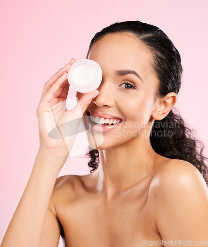 Image of Face, skincare and woman smile with cream container in studio isolated on a pink background. Portrait, beauty and happy model with moisturizer, sunscreen cosmetic or dermatology product for wellness