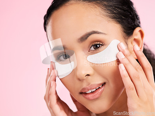 Image of Beauty, face mask and eye patch of a woman with skin care, dermatology and natural glow. Portrait of a young female aesthetic model with cosmetics product for collagen and detox on a pink background