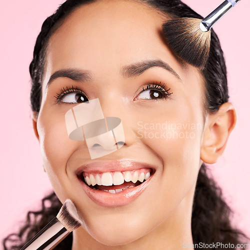 Image of Product, makeup and brush with face of woman in studio for foundation, cosmetics and facial. Skincare, health and self care with female model on pink background for dermatology, glow and beauty