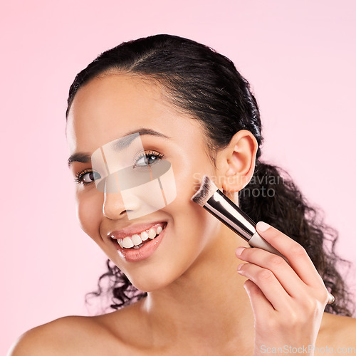 Image of Smile, makeup and brush with portrait of woman in studio for foundation, cosmetics and facial. Skincare, health and self care with female model on pink background for dermatology, beauty and product