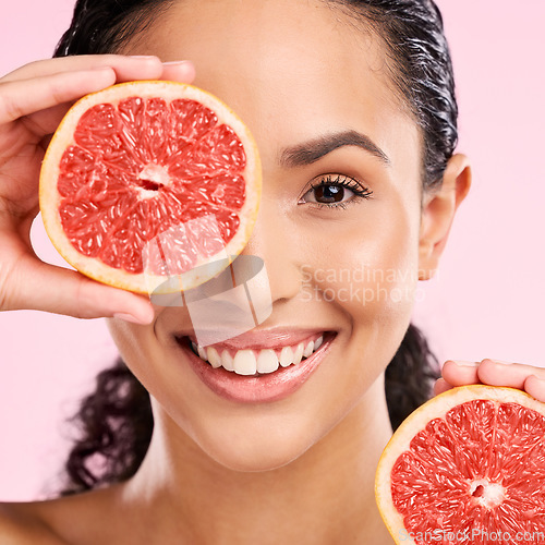 Image of Grapefruit, beauty and face portrait of a woman with skin care, dermatology and natural glow. A happy young female aesthetic model with fruit for vitamin c, cosmetics or healthy diet and nutrition