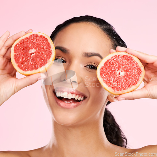 Image of Face, grapefruit and beauty portrait of a woman with skin care, dermatology and natural glow. Happy young female aesthetic model with fruit for vitamin c, cosmetics or diet nutrition for detox