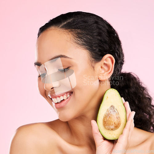 Image of Smile, skincare and woman with avocado in studio isolated on a pink background. Happy, natural cosmetic or model with fruit, food or nutrition for healthy diet, vegan or omega 3 benefits for wellness