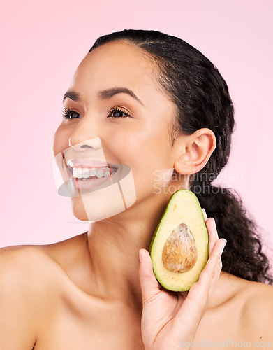 Image of Avocado, skincare and happy woman thinking of healthy facial, natural cosmetics and beauty ideas. Young african person or model green fruit for vegan product and dermatology on pink studio background