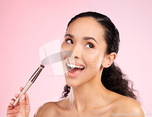 Image of Cosmetics, makeup and brush with face of woman in studio for foundation, beauty and facial. Skincare, health and self care with female model on pink background for dermatology, glow and product