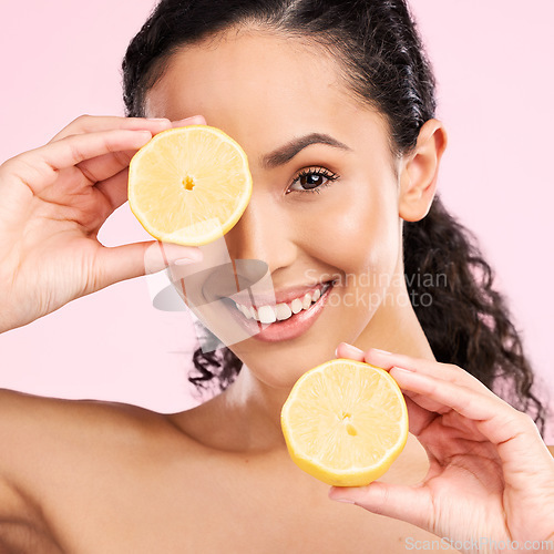 Image of Woman face, skincare portrait and lemon for beauty, cosmetics and natural product or vitamin c benefits. Happy, young person or model with fruits for eye dermatology on a pink, studio background