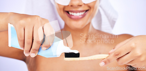 Image of Toothpaste, toothbrush and woman with an oral care routine in a studio for health and wellness. Smile, dental hygiene and closeup of female model getting ready to brush her teeth by white background.