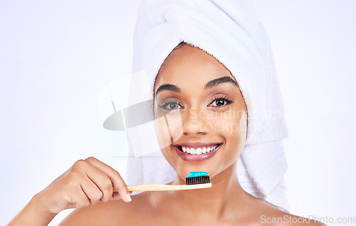 Image of Toothbrush, dental care and portrait of a woman in a studio for a health and wellness routine. Smile, oral hygiene and headshot of young female model brushing teeth isolated by white background.