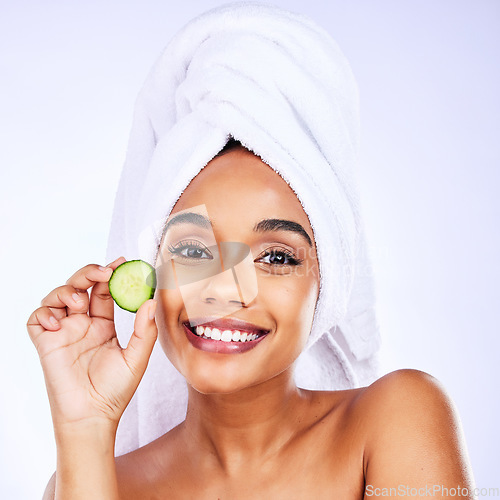 Image of Skincare, cucumber and portrait of Indian woman in studio happy with detox, wellness or hydration treatment on grey background. Fruit, beauty and face of female smile for natural, vegan or diy facial