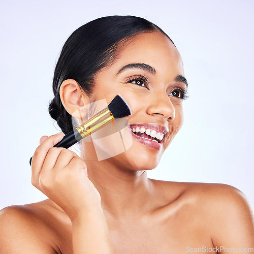 Image of Beauty, makeup brush and cosmetics of a happy woman in studio for skincare, self care and cosmetology. Skin glow, shine and wellness of a female model with facial application tools for foundation