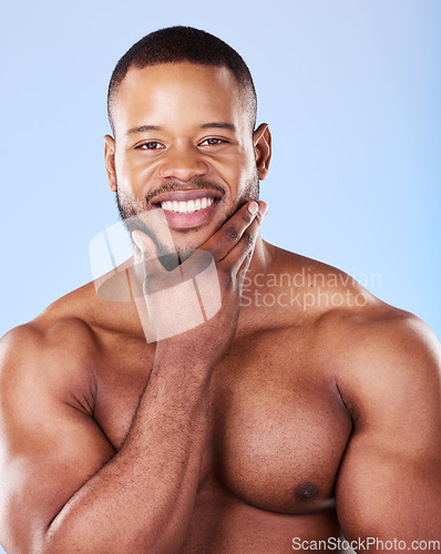 Image of Skincare, portrait of black man with hand on face, studio and luxury skin care morning routine. Dermatology, spa cosmetics and facial beauty glow for wellness, happy model isolated on blue background