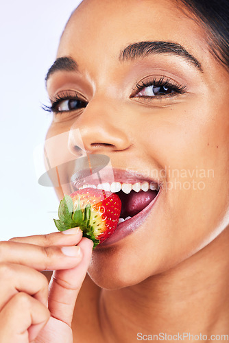 Image of Portrait, strawberry and Indian woman in studio for health, diet and detox, nutrition and wellness. Fruit, berry and face of lady with natural, vegan or organic snack for weight loss and antioxidants