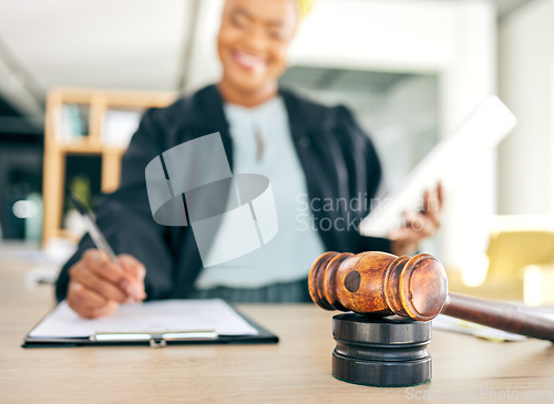 Image of Legal, gavel and judge writing for an investigation document, contract or criminal case in a law firm. Court hammer, administration and lawyer working on justice or planning policy in attorney office