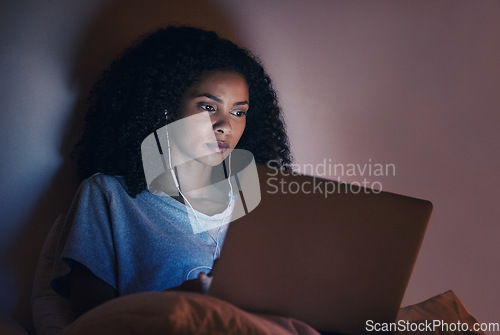 Image of Laptop, bedroom and woman with music at night for radio, podcast sound and online social media in home. Bed, computer and person with earphones streaming movie, film and video on tech with insomnia