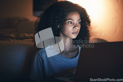 Image of Laptop, bedroom and woman on internet at night for website, online social media or remote work in home. Bed, computer or serious African person streaming movie, film or video on pc tech with insomnia