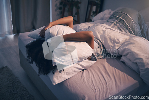 Image of Bedroom, insomnia and woman with pillow on face, tired and frustrated with stress, nightmare or dream. Fatigue, sleep problem and exhausted girl in bed with fear, scared at night and crisis in home.