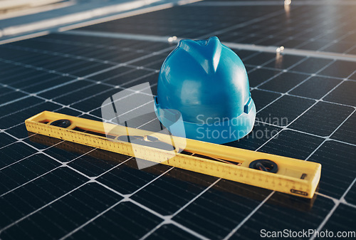 Image of Solar panel, level tools and helmet for renewable energy isolated for maintenance and construction. industry, sustainability and engineer equipment on a rooftop for eco friendly project and safety