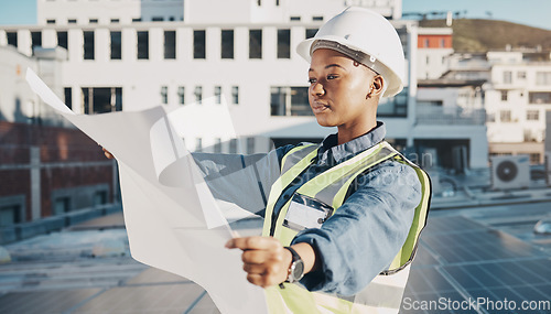 Image of Female engineer, solar panel blueprint or outdoor on rooftop for power, sustainability plan or energy development. Black woman, photovoltaic tech or reading on roof, analysis or illustration in metro