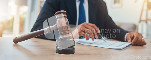 Image of Documents, judge and gavel with hands of man in lawyer office for justice at legal hearing. Attorney, advocate and closeup of crime, hammer of person in law firm and courtroom, paperwork or signature