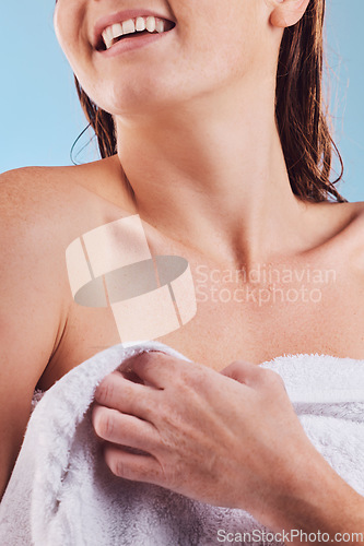 Image of Happy woman, hands and towel in shower for hygiene, clean body or washing against a blue studio background, Closeup of female person smile for bathroom routine, self care or grooming in cleanliness