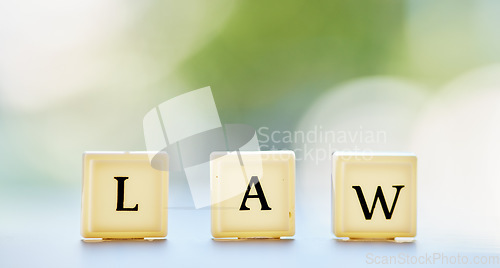 Image of Law letter, and table with block cubes in outdoor blur with mock up space for justice or attorney. Legal, alphabet and questions for support or services in brokeh background with regulation for help.