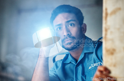 Image of Flashlight, security guard and man in dark room for investigation, inspection and property search at night. Surveillance, law and police officer with torch for safety, crime and protection service
