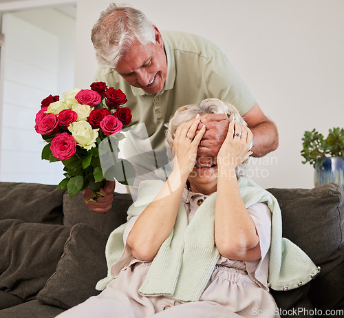 Image of Senior couple, surprise and flowers gift for love and valentines day in a home. Living room couch, closed eyes and smile with elderly woman and man together in retirement with bouquet in a house