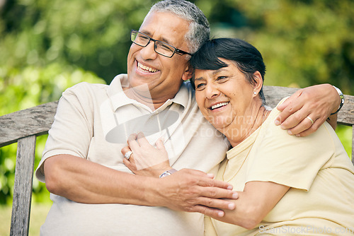 Image of Happy, love and relax with old couple on park bench for retirement, smile and garden. Happiness, hug and care with senior man and woman on bench in nature for romance, bonding and wellness together