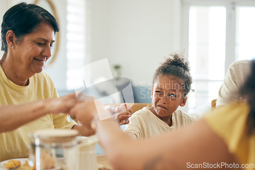 Image of Family home, lunch and holding hands for praying together, religion or faith with comic girl child at table. Grandmother, kid peeping and prayer for food, celebration or party in house for blessing