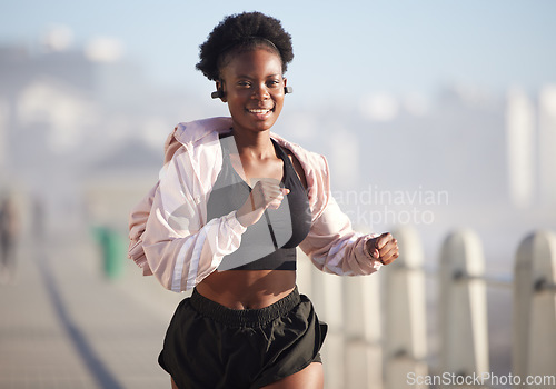 Image of Portrait, running and black woman outdoor with music earphones, radio and podcast. Sports, fitness and happy African athlete training, workout and exercise for healthy body, wellness and cardio