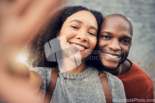 Image of Face, interracial couple and selfie outdoor, happy and bonding together for memory in urban city. Portrait, smile and African man and woman with profile picture, photography and social media on date